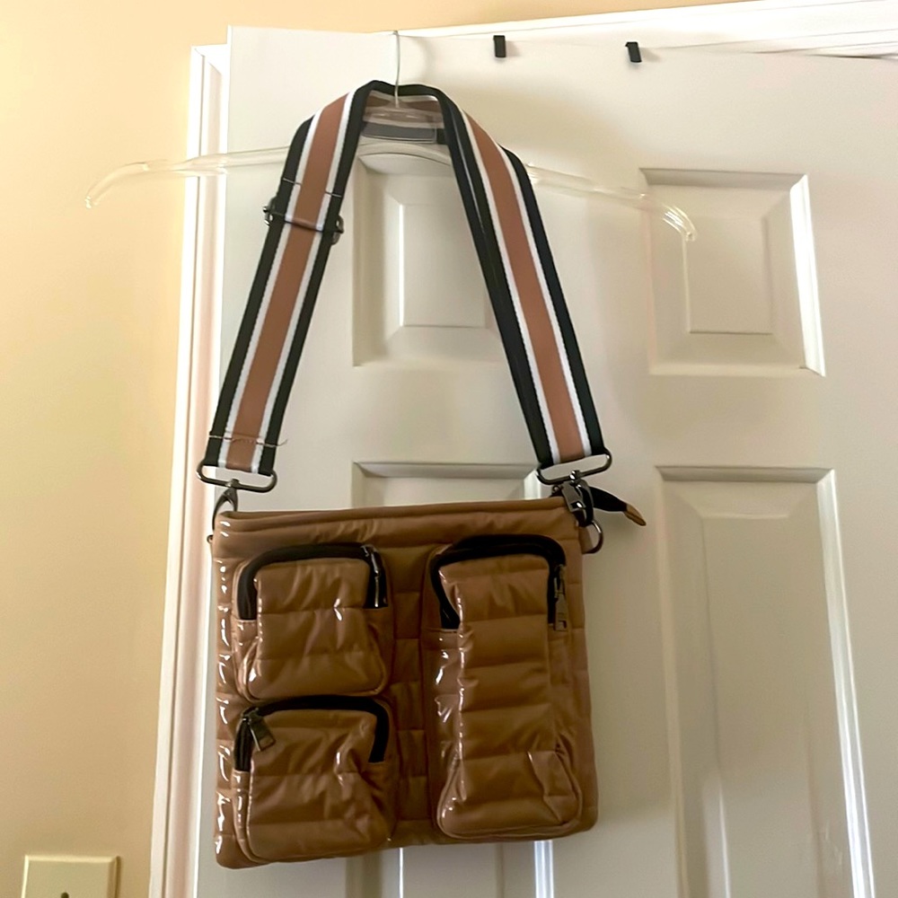 Tan puffer Crossbody bag with guitar strap.